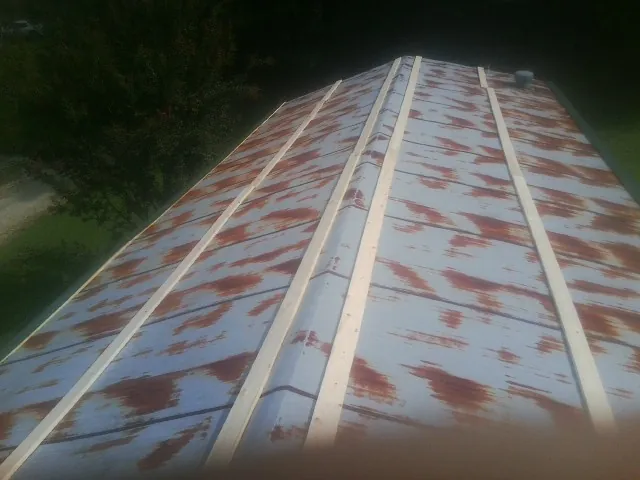 Rusted metal roof panels with new wood purlins before replacement — Storm Damage Roof Repair in Deersville by Roofing Brothers